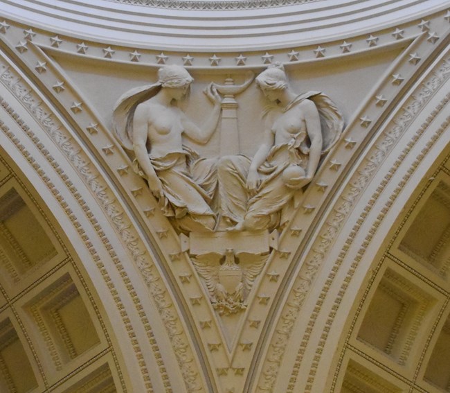 White granite pendentive architecture of two allegorical women
