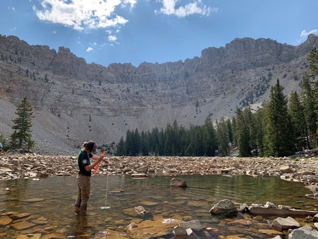 Staff member taking depth measurements in Baker Lake