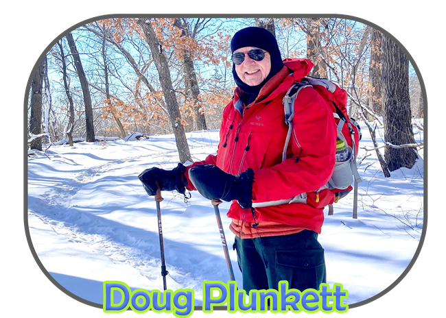 Volunteer Doug Plunkett hiking in the winter   surrounded by a snow landscape.