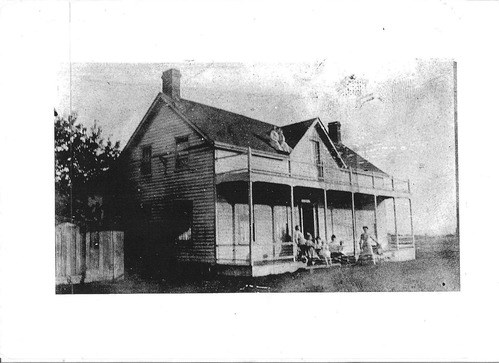 Historic photo of the ferry house with people out front and on the roof