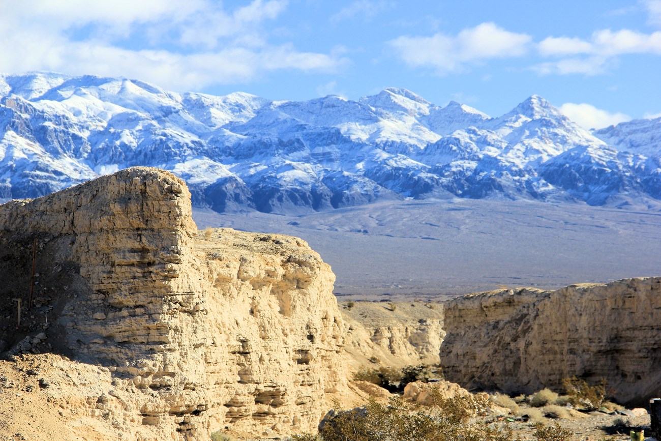 desert wash landscape with high peaks in the distance