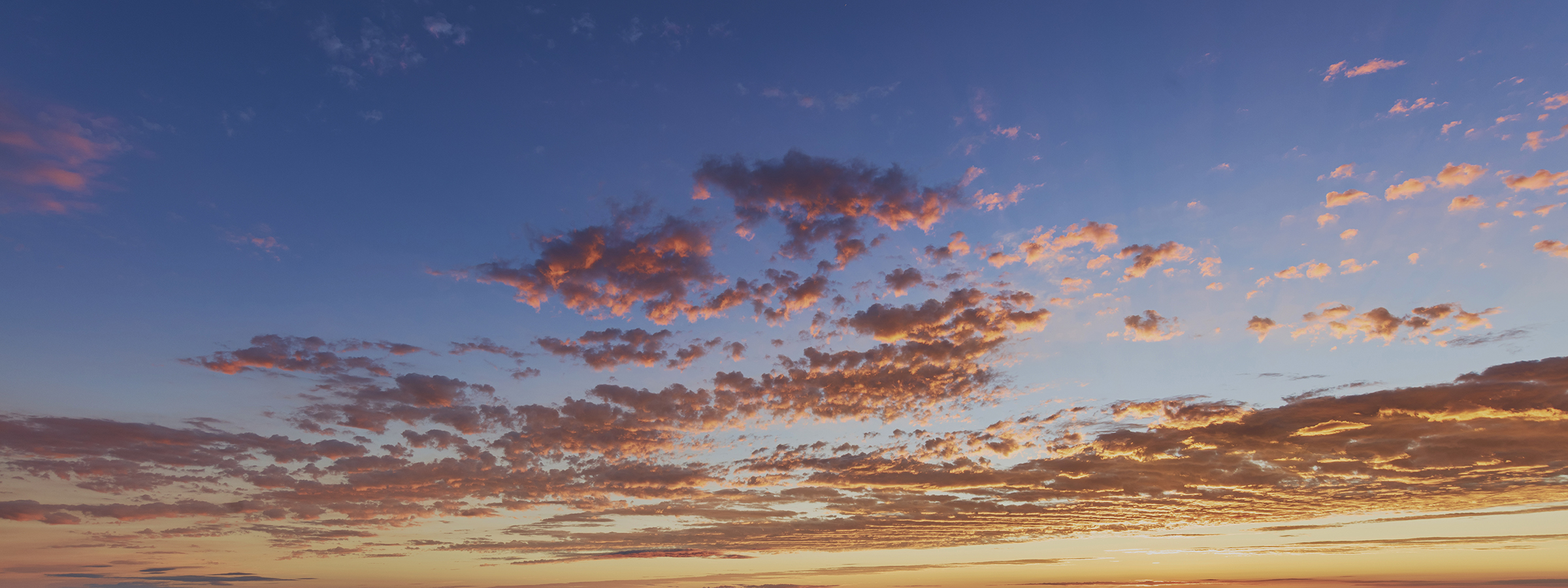Pink clouds in a blue sky.