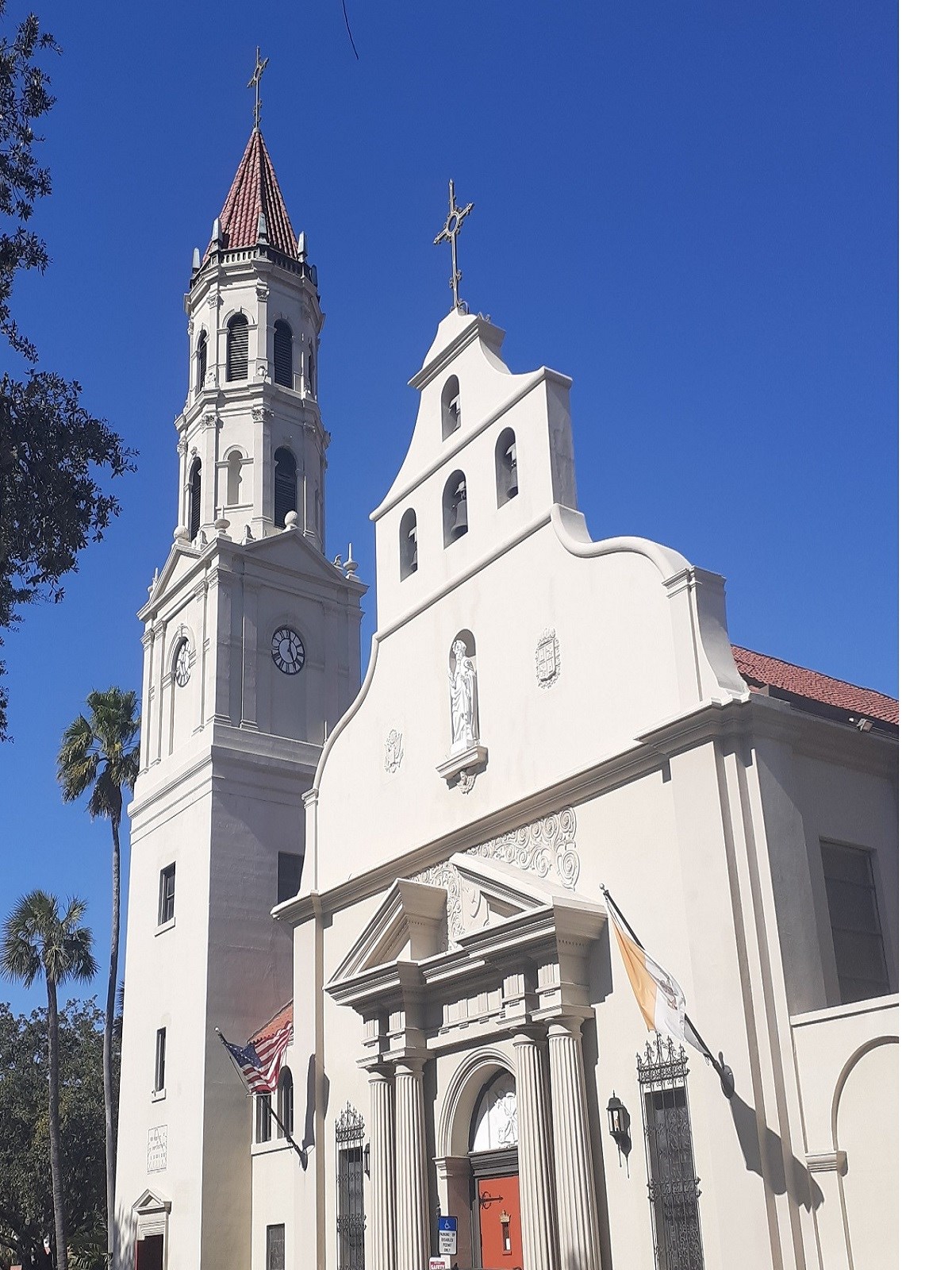 Church with tower and front wall extending up past roof above front door