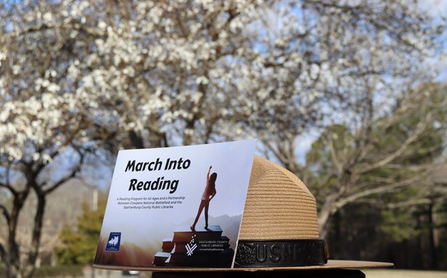 March Into Reading booklet on top of a ranger hat