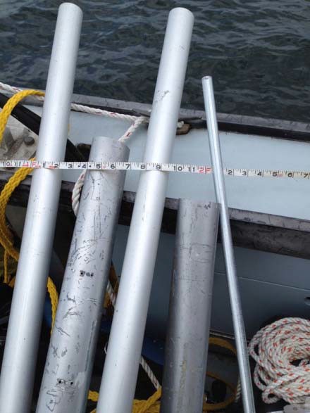 Five metal tubes of various sizes and thicknesses with a measuring tape against them.