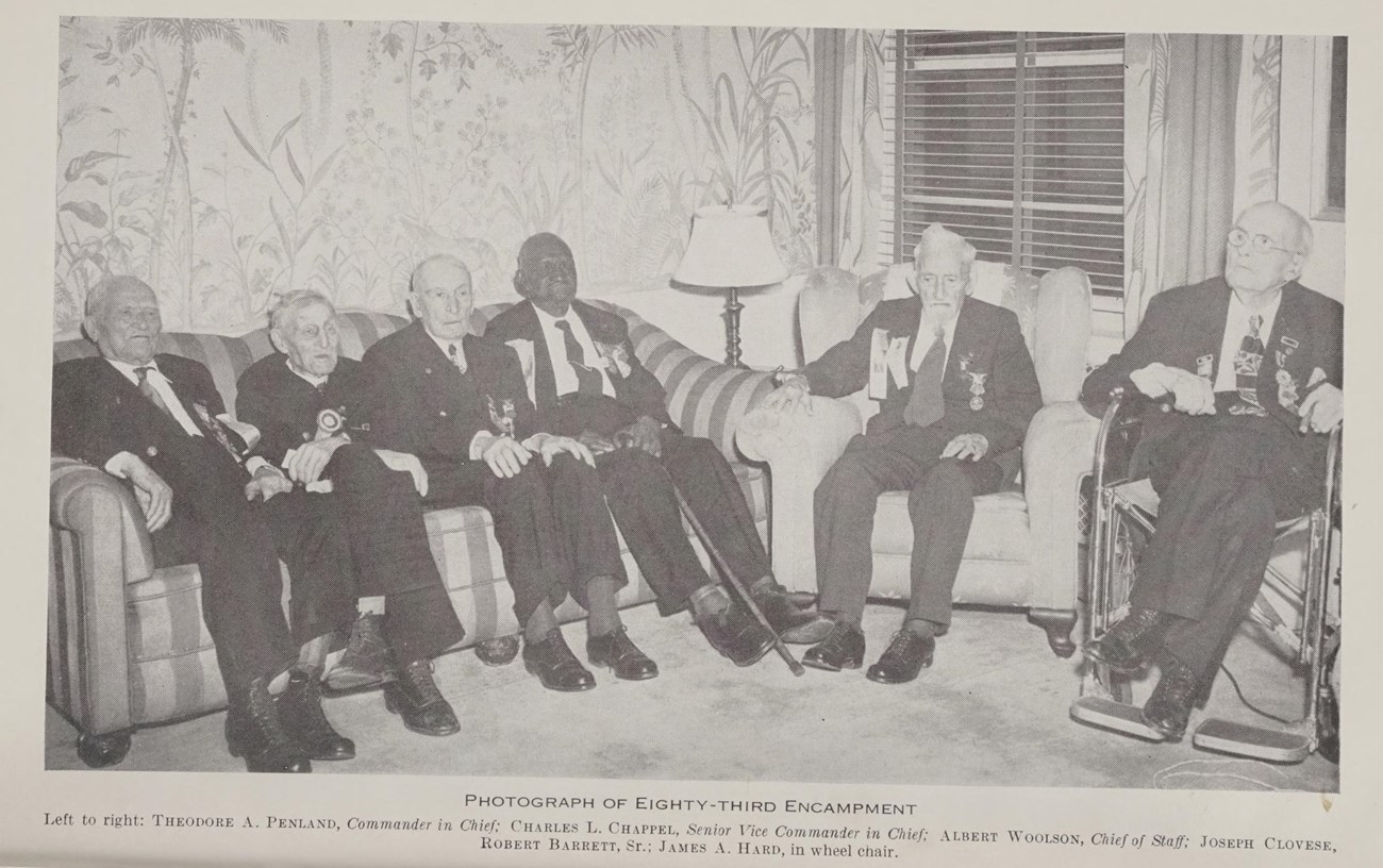 The only six members of the Grand Army of the Republic, including final surviving African American Civil War veteran Joseph Clovese, present at the final reunion of the G.A.R in 1949. Four men sit on a couch, one man in a chair, and one in a wheelchair.