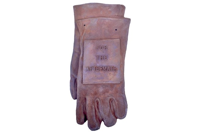 A pair of gloves in cast iron with "For the Aftermath" on them