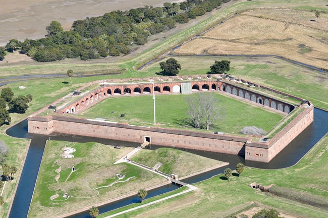 An aerial view of a brick five-sided fort.