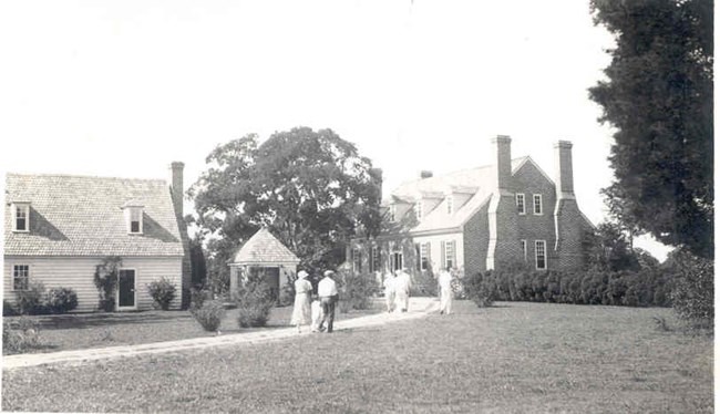 black and white image of the wooden colonial kitchen and brick memorial house museum