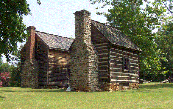 Two stone cabins are shown with trees in the background.