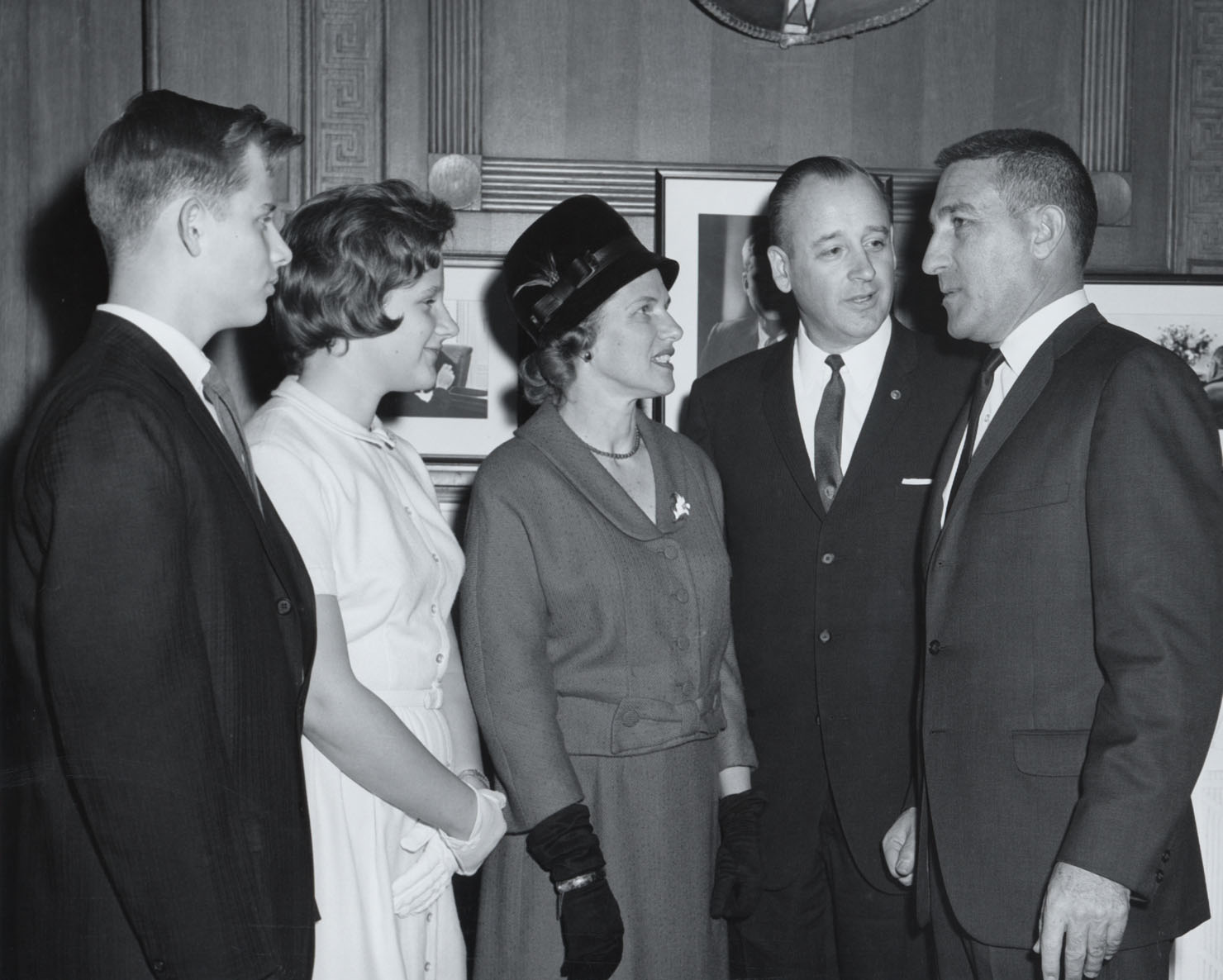 Four Hartzogs stand next to Steward Udall inside an office