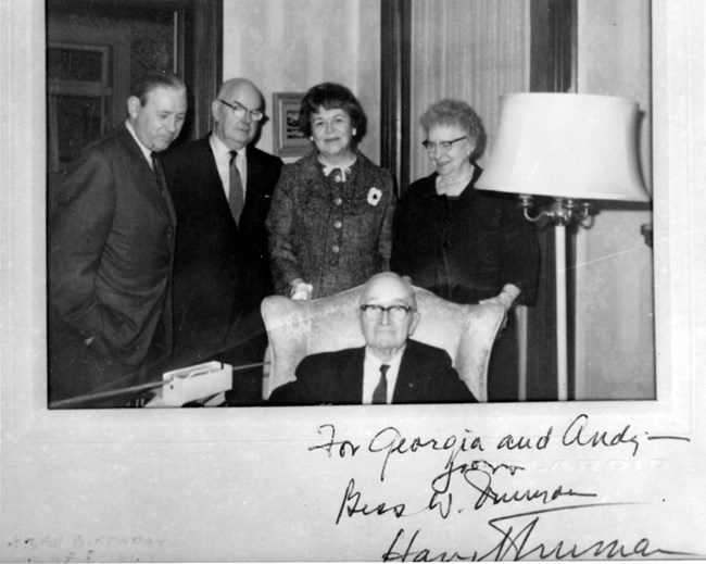 Group of visitors gathered around Harry and Bess Wallace Truman