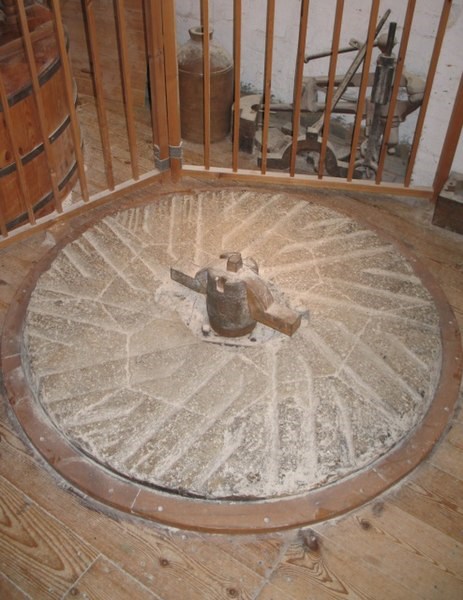 A picture of a bed grinding stone inside a historic English mill.