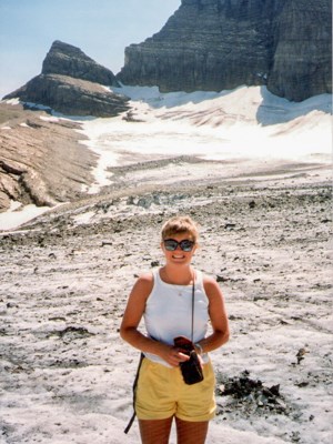 An old photo of a young person standing on a glacier