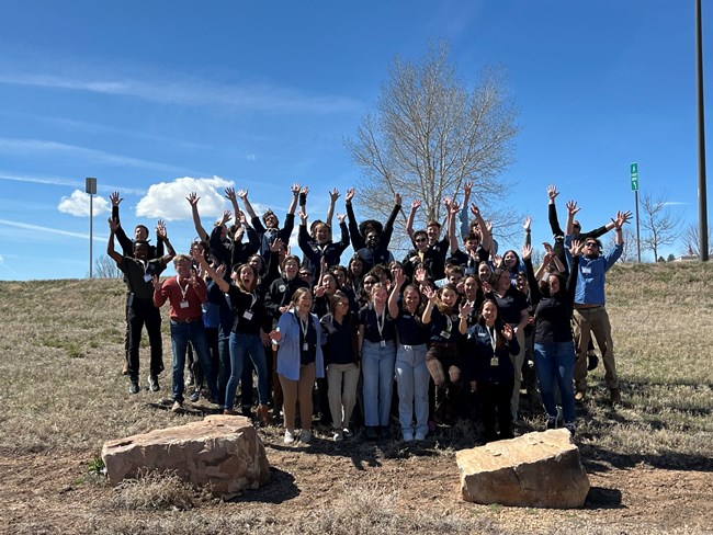 Community Volunteer Ambassadors jump for a group photo