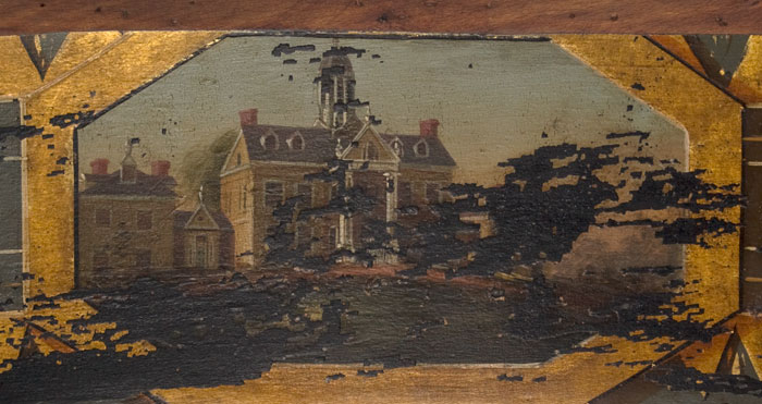 A close up look of the detail on a painted chair depicting Hampton Hall.