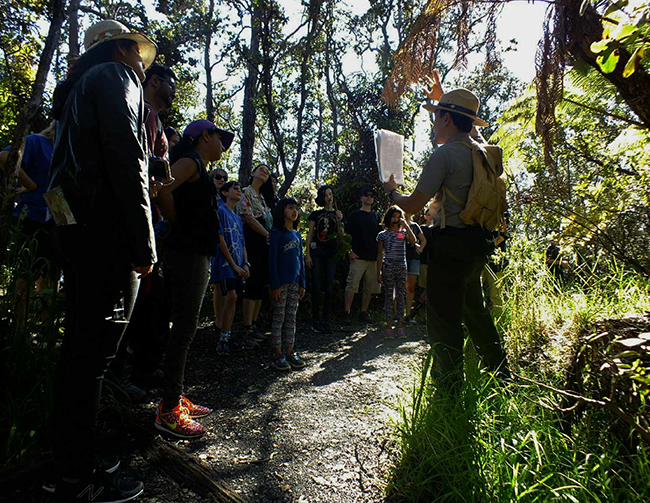Ranger showing a graphic to visitors on a ranger program.