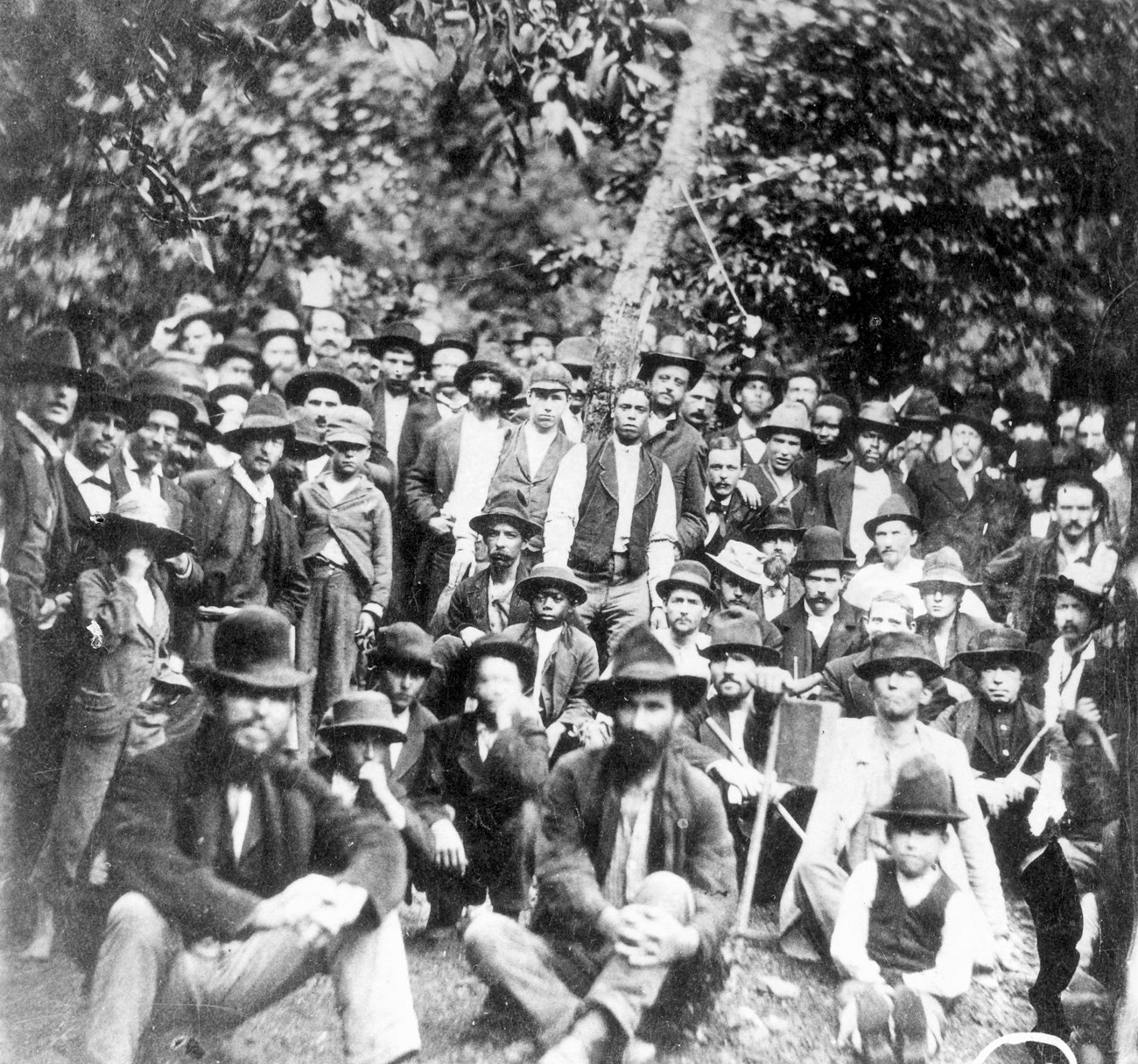 Large group of men gathered at a meeting outside