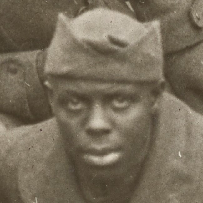 African American Soldier wearing World War One uniform looking at the camera