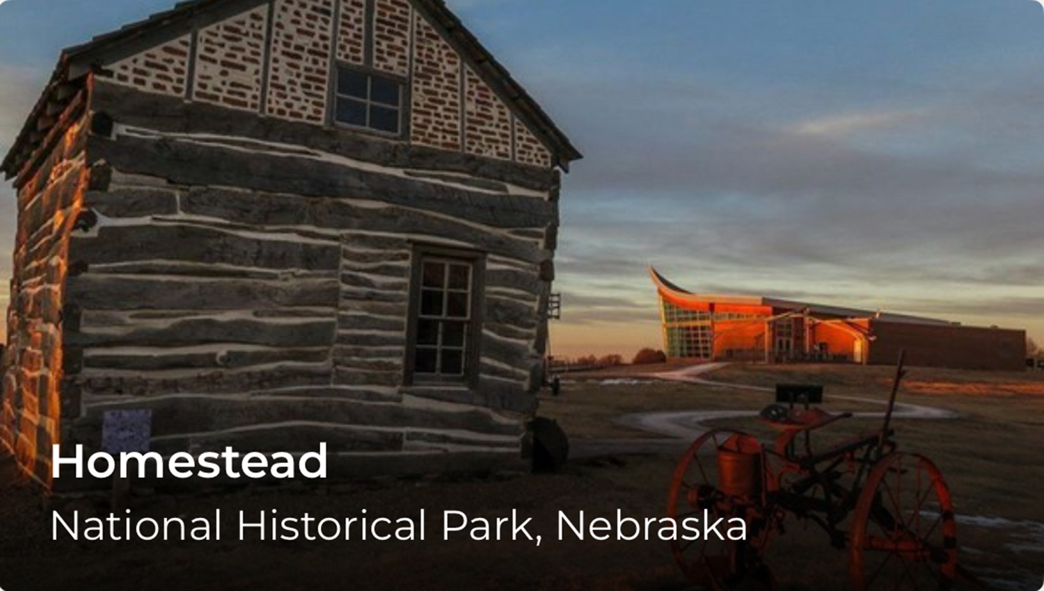 A historic wooden building with words in the lower left corner that read Homestead.