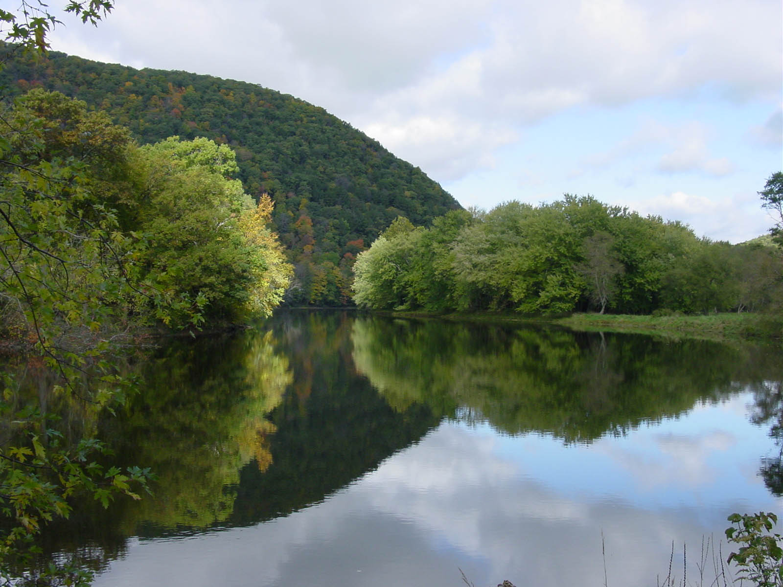 A flat, calm view of the Housatonic River in early fall