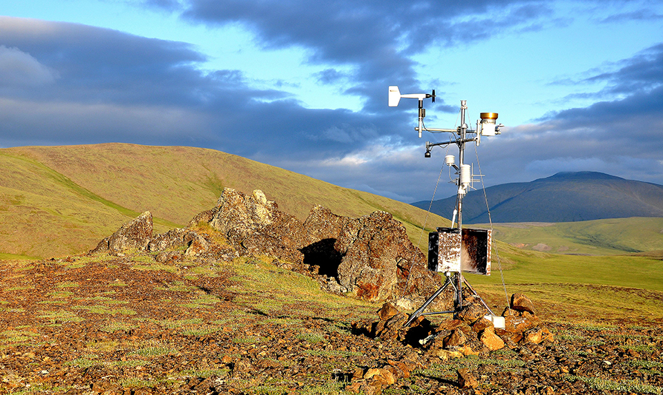 Climate station basks in the golden hues of an Arctic evening at Howards Pass, Noatak National Preserve
