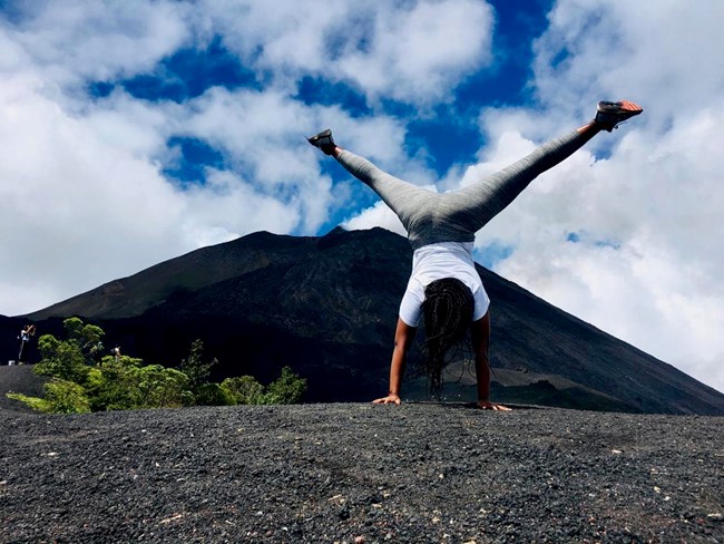Alyssa doing a cartwheel with mountains in the background