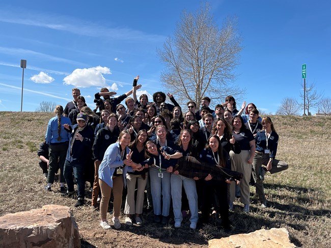 Community Volunteer Ambassadors hold funny poses for a group photo