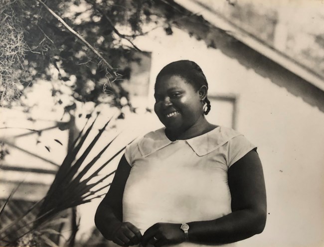 Vermelle Stafford smiles in front of an Eldora home.