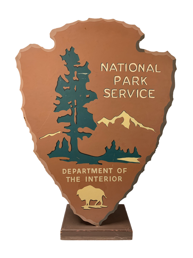 Brown arrowhead plaque on a stand