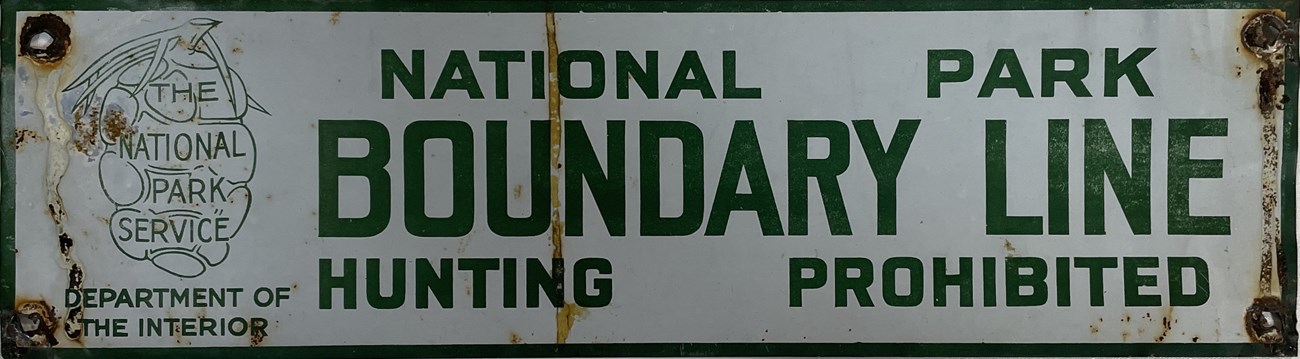 rectangular white sign with green letters and sequoia cone