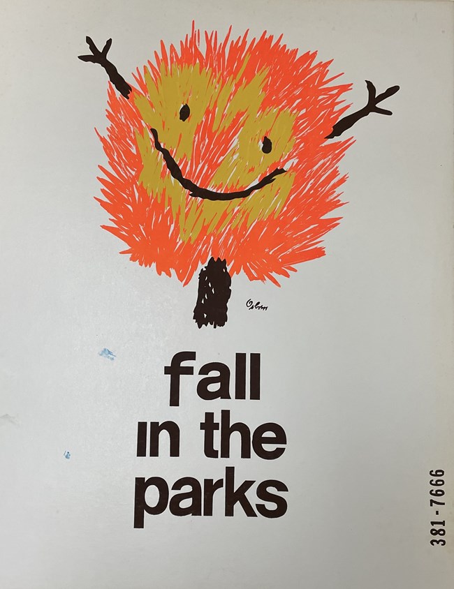 Bushy orange and yellow tree with a smile and upraised arms