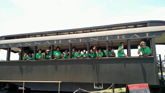 Girl Scouts on the site tour by train during the Juliette’s Family Tree program.
