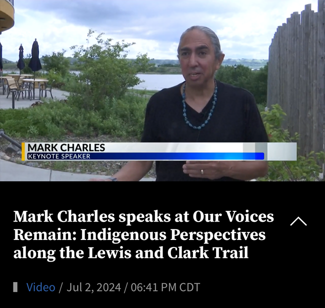 A news channel interview of a man with his hair pulled back