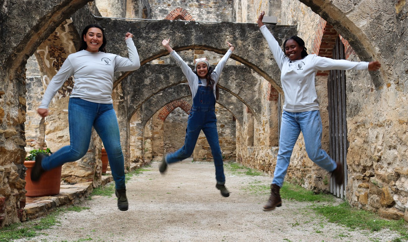 three woman jump for a picture