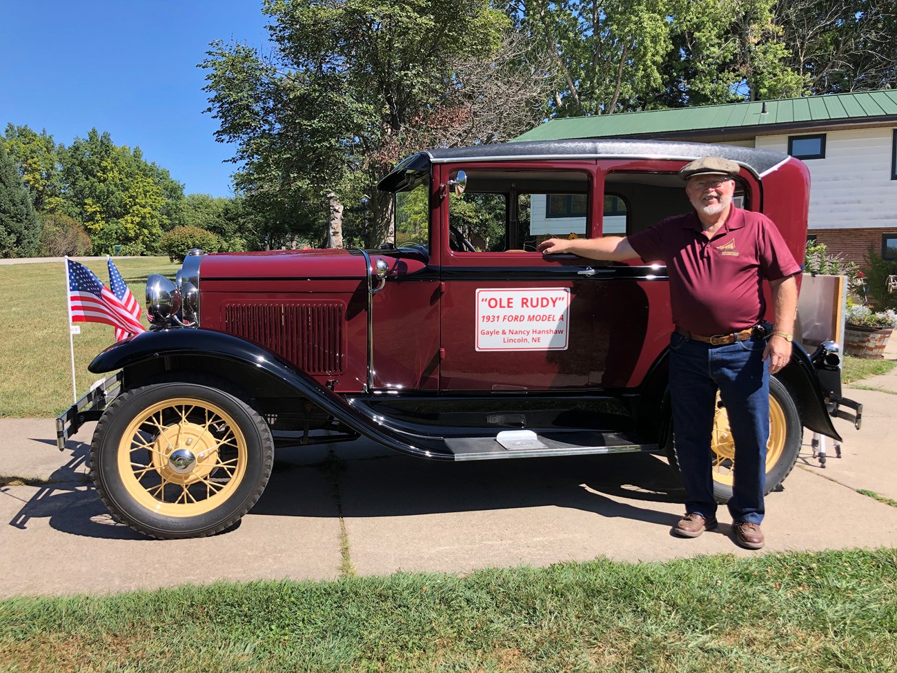 A man stands next to his 1931 restored model A