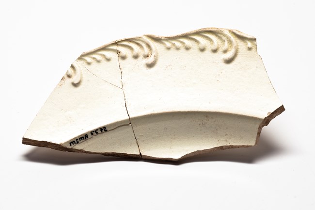 Edge of a feather-edged creamware plate