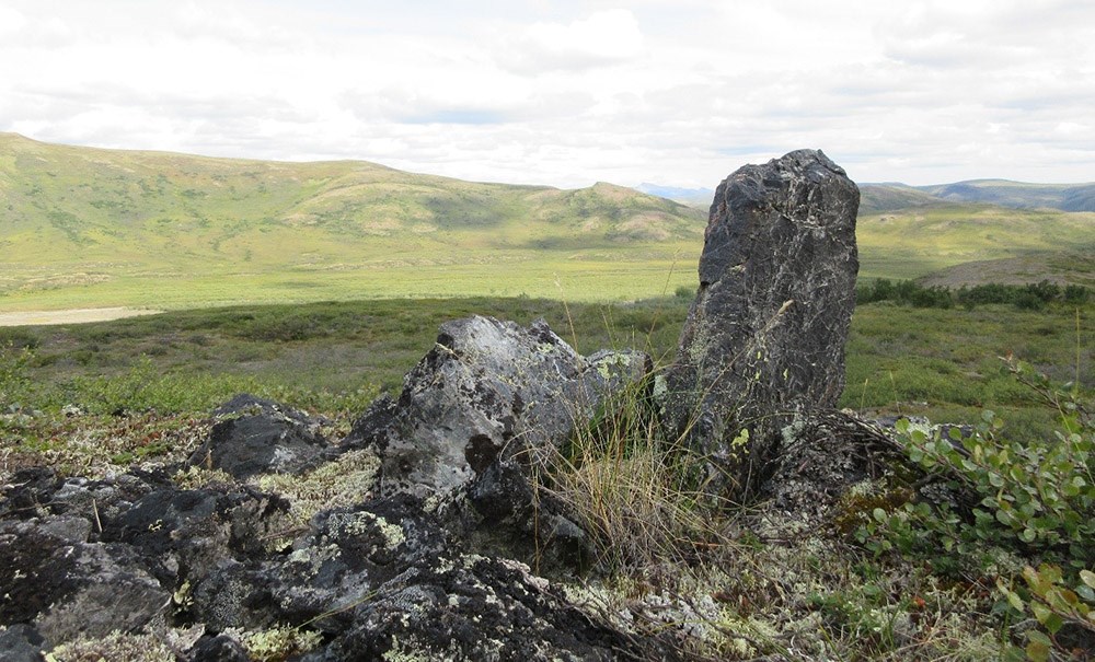 A stone monument stands on the tundra that has been used for centuries to herd caribou.