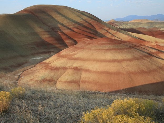 Photo of hills with layered bands of rock