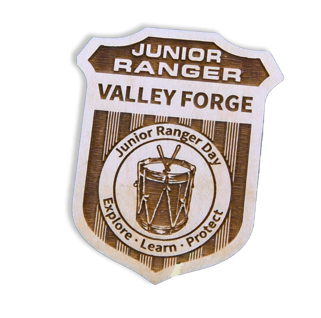 wooden junior ranger badge with drum graphic. Valley Forge Junior Ranger Day, Expore, Learn, Protect
