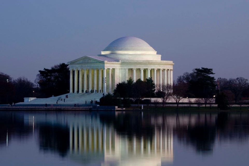 White marble building with columns at night