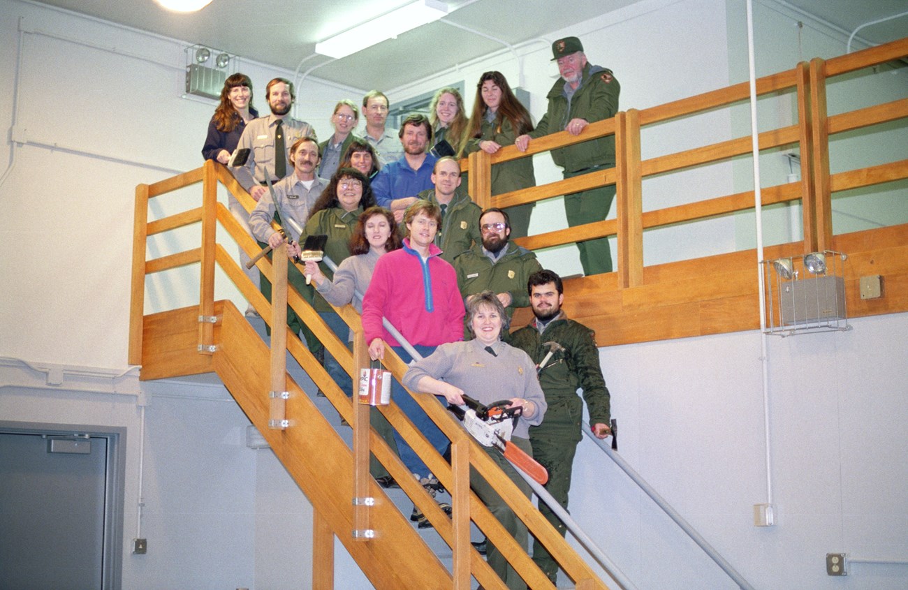 Several people, some in NPS uniform some not, pose on a staircase