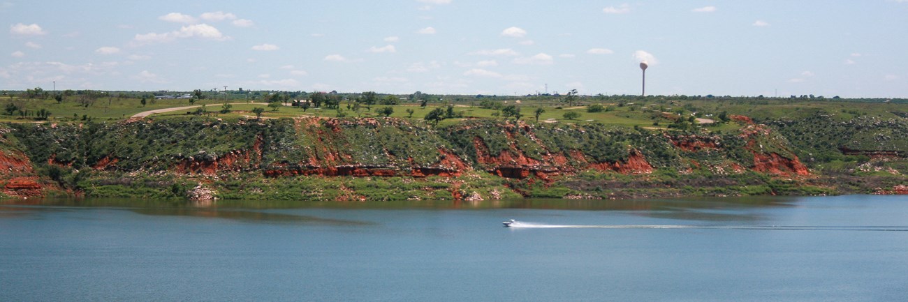 A boat speeds its way across Lake Meredith.