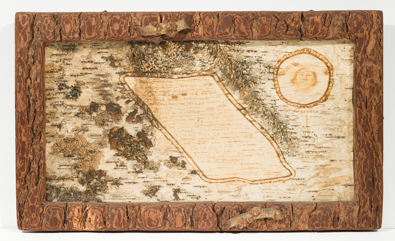 Birchbark panel with rustic bark surface, text, and small portrait in bark frame.