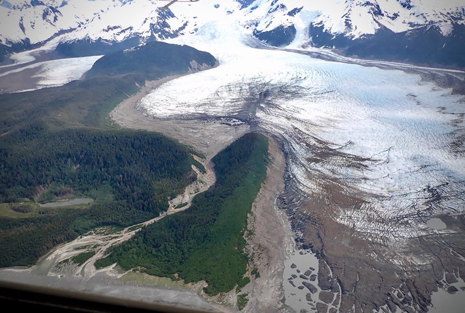 An aerial view of a glacier with adjacent forests.