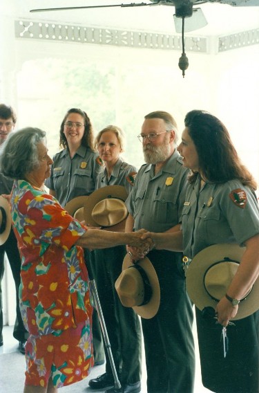 Lady Bird Johnson on the back porch of the Truman home with park staff (left to right) Dave Shafer, Christie Thurston, Becky Railey, Norton Canfield, and Jenny Hayes.