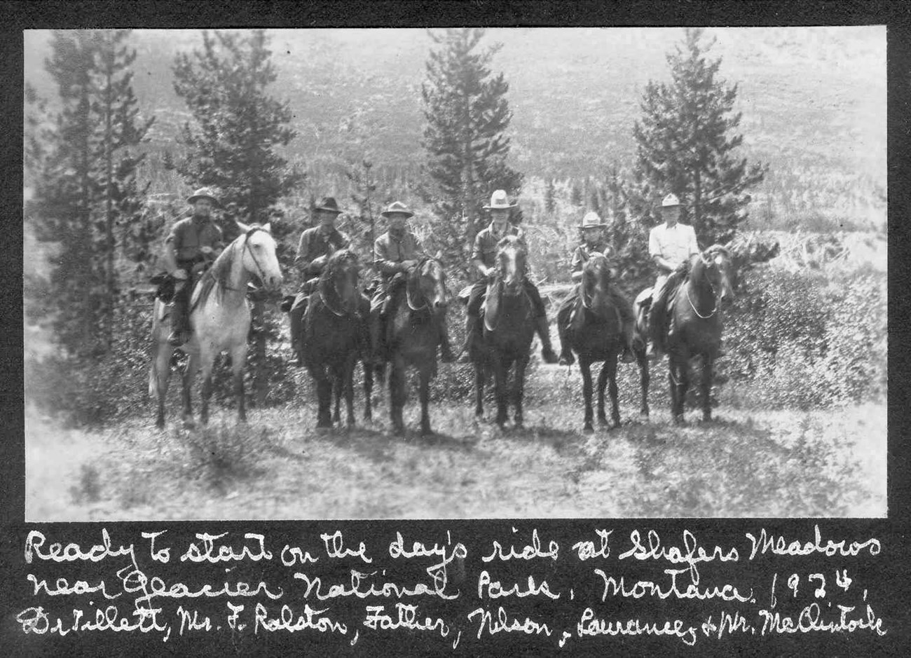 black and white photo of group of people on horseback with writing below