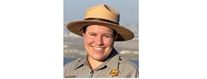 Smiling woman in NPS uniform and hat