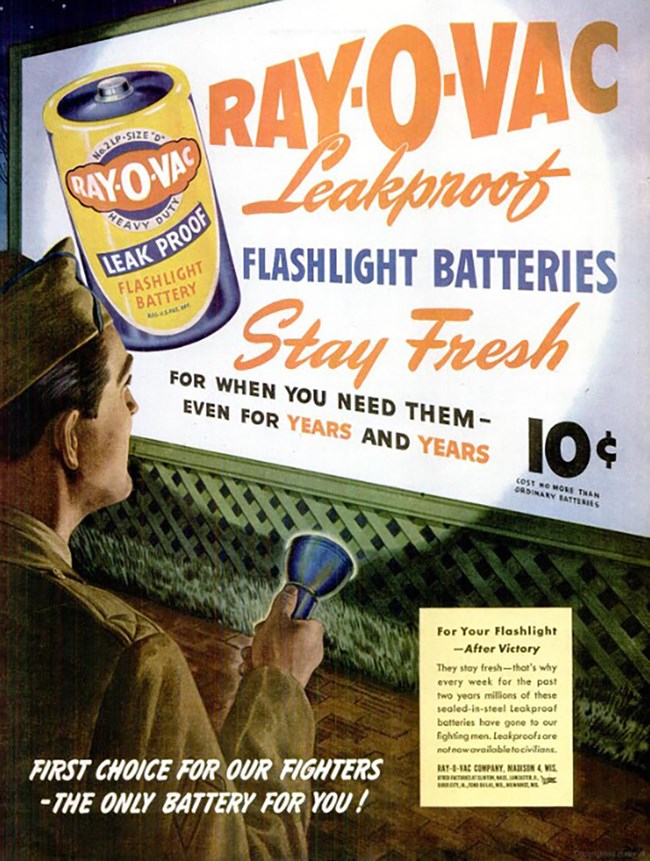 An illustrative color ad. A white soldier in uniform shines a flashlight on a billboard advertising Ray-O-Vac batteries. “Flashlight batteries stay fresh for when you need them – even for years and years. 10 cents.”