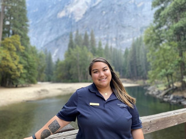 Lei smiling posing for a picture with lake and mountains in the back